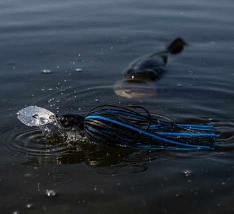 Night bass fishing lure—spinnerbait or chatterbait under moonlight creating vibration and motion, Master Fishing Guide 2025