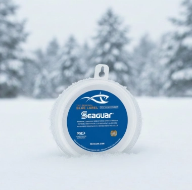 Fluorocarbon leader line spool on snow for winter pike fishing