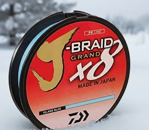 Winter fishing line spool on snow for cold-water pike fishing