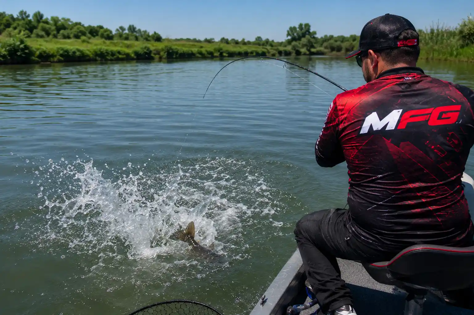 Topwater pike fishing from a boat — MFG angler fighting a summer pike