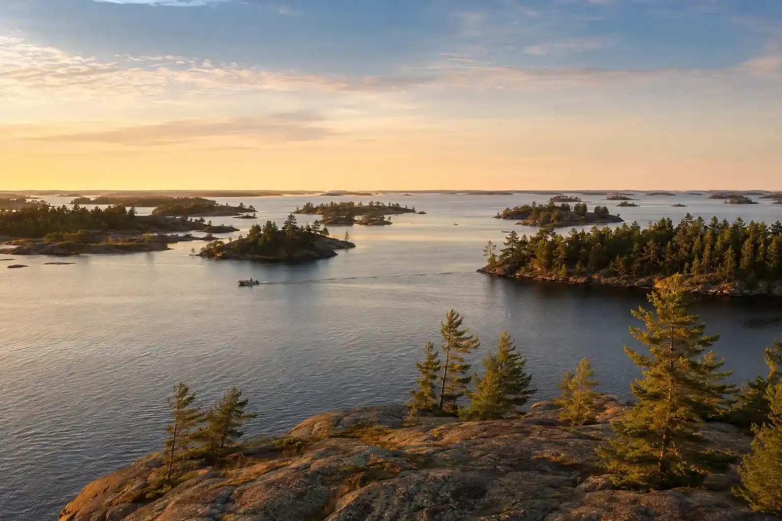 Rocky, pine-covered islands on Lake of the Woods during one of our fishing trips, one of the well-known waters where pike and muskie share the same habitat