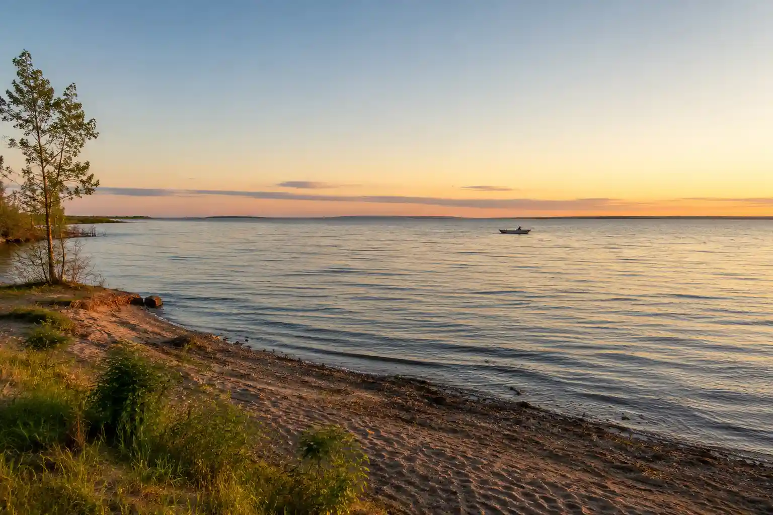 Open water and shoreline of Mille Lacs Lake, Minnesota during one of our evening fishing sessions, a boat visible in the distance