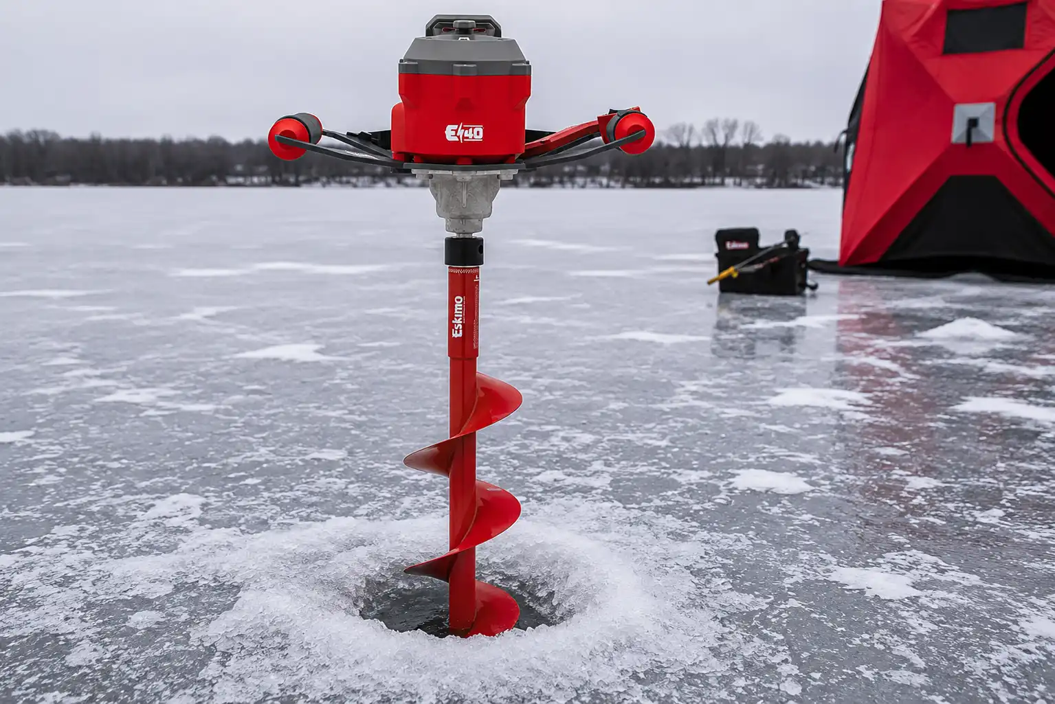 Electric ice auger drilling a hole through pike ice
