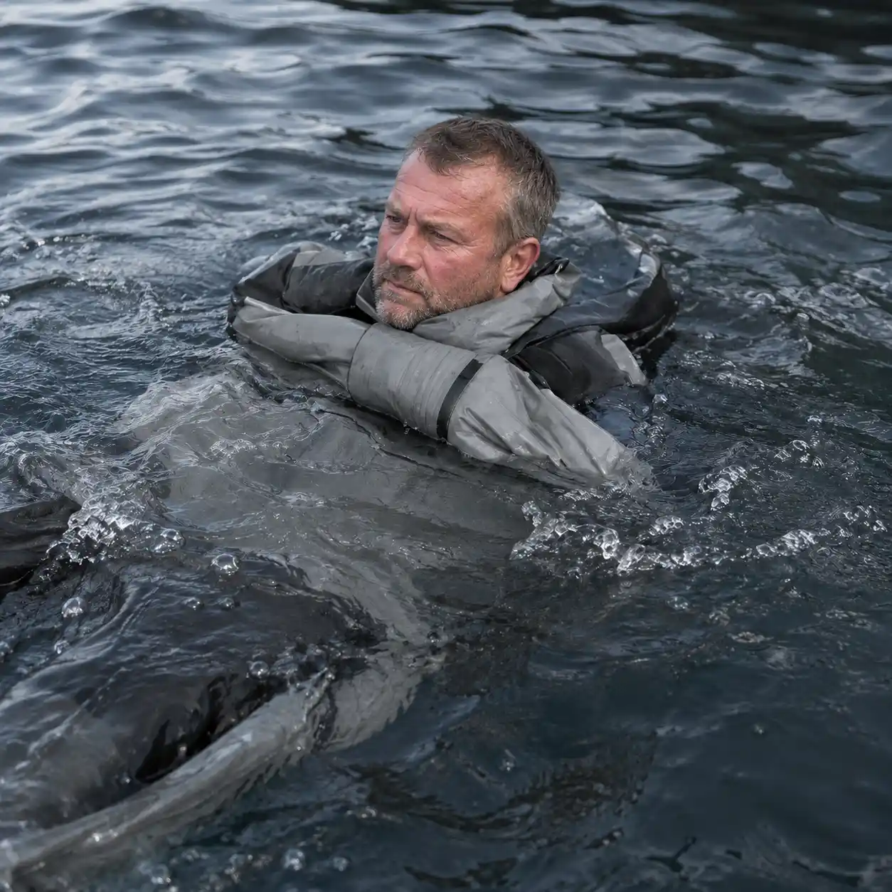MFG tester testing the WindRider Boreas suit's buoyancy in open water
