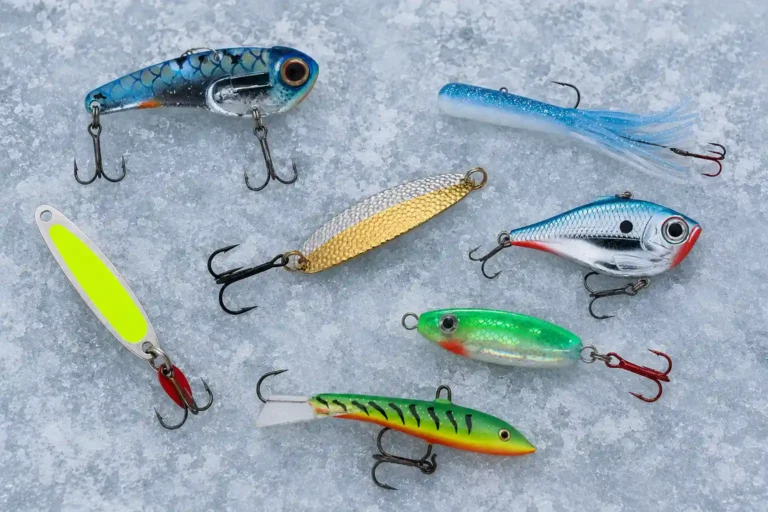 Our tested assortment of ice fishing lures for pike including spoons, swimbaits, and jigs on ice
