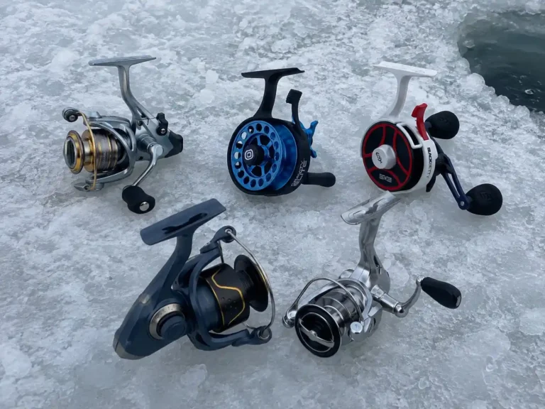 Five ice fishing reels we field-tested for pike, laid out on the ice next to our fishing hole