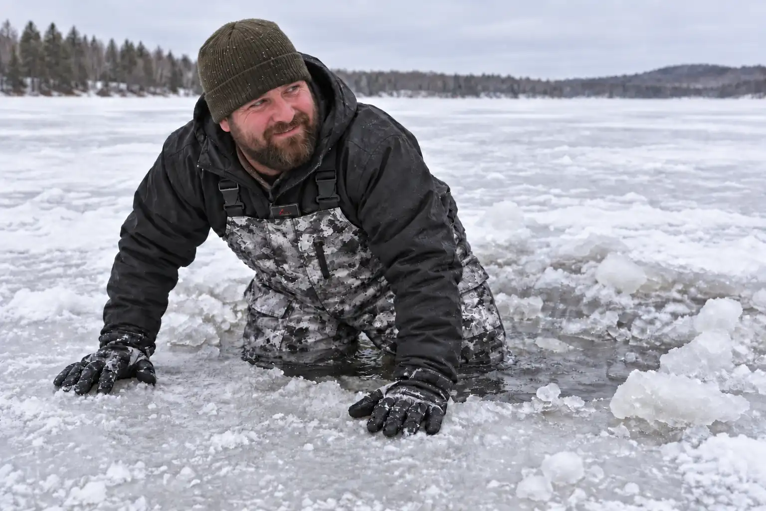 MFG team member wearing Piscifun Ice Fishing Bibs during an unplanned knee-deep breakthrough while testing flotation, drainage, and movement on the ice
